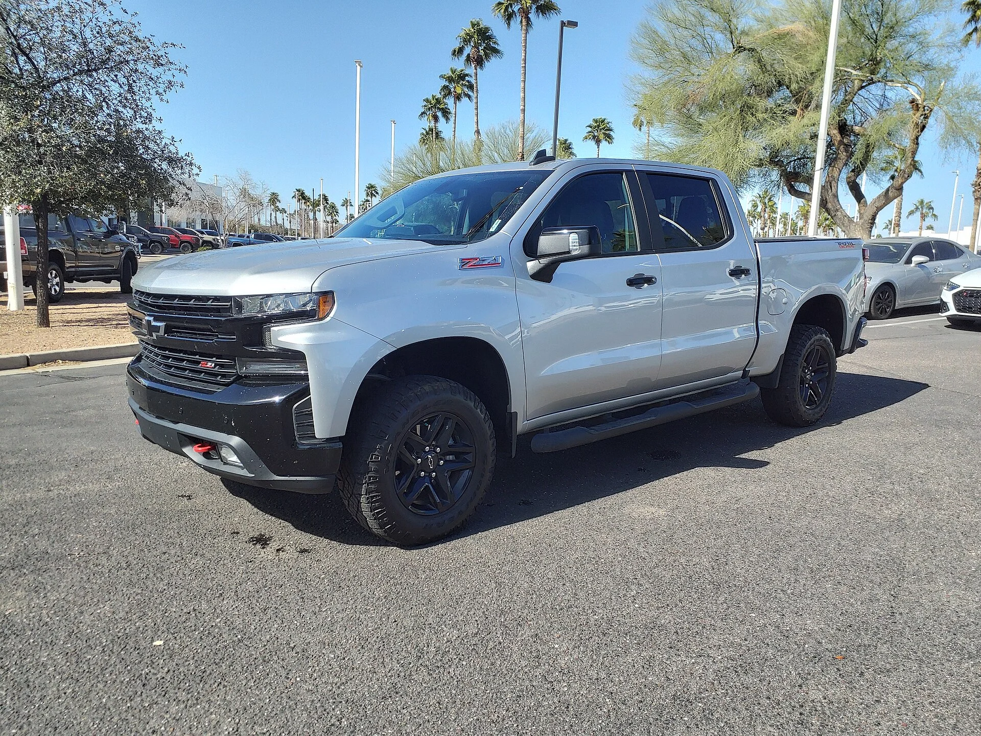 Three full-size pickup trucks, representing the 2026 Chevrolet Silverado 1500, Ford F-150, and Ram 1500